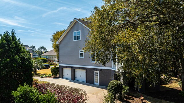 4233 Haulover Dr, Johns Island, SC 29455 - view of side of property with an attached garage and driveway