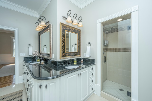 bathroom featuring vanity, ornamental molding, a shower with shower door, and tile patterned flooring