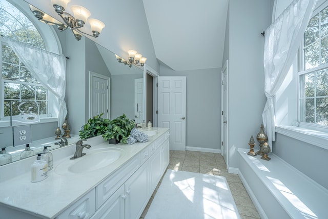 4233 Haulover Dr, Johns Island, SC 29455 - full bath with a chandelier, plenty of natural light, tile patterned floors, double vanity, and vaulted ceiling