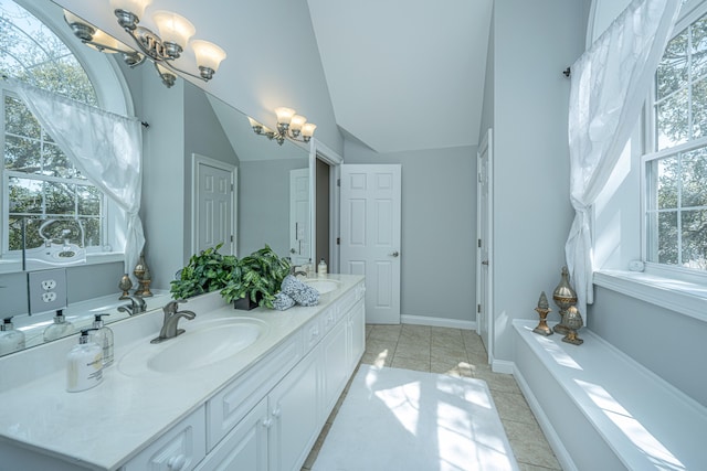 bathroom featuring vanity, lofted ceiling, a notable chandelier, and tile patterned floors