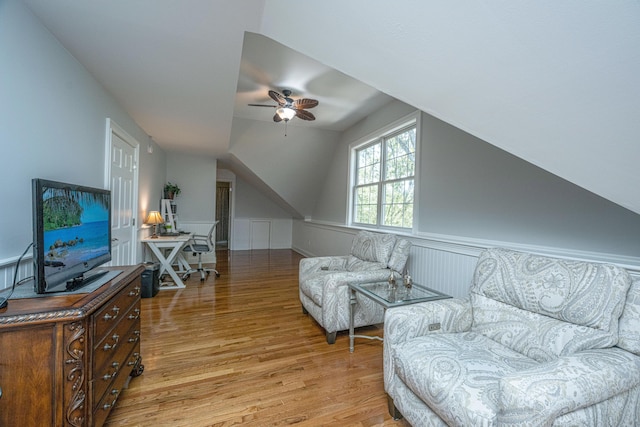 4233 Haulover Dr, Johns Island, SC 29455 - living room featuring light wood finished floors, ceiling fan, vaulted ceiling, a desk, and a wainscoted wall