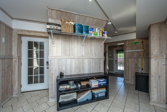 4233 Haulover Dr, Johns Island, SC 29455 - doorway to outside featuring light tile patterned floors, wood walls, and rail lighting