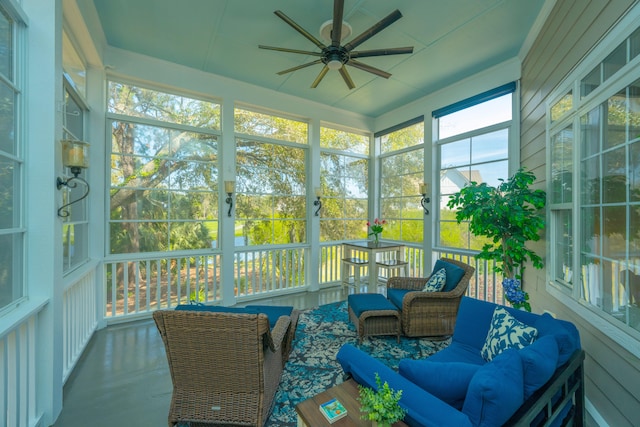 sunroom / solarium featuring ceiling fan