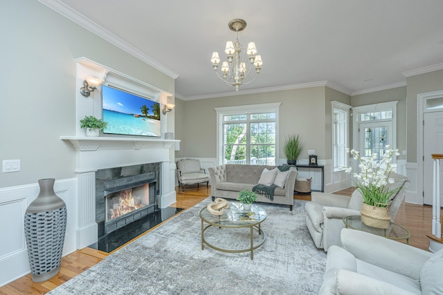 living room featuring ornamental molding, a chandelier, and hardwood / wood-style flooring