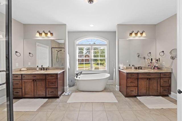 241 Clubside Dr, Lexington, SC 29072 - bathroom featuring a tile shower, a freestanding tub, two vanities, and tile patterned flooring