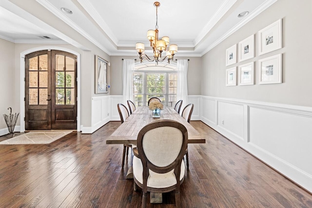 241 Clubside Dr, Lexington, SC 29072 - dining room featuring french doors, a chandelier, wood-type flooring, a raised ceiling, and a decorative wall