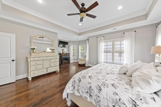 241 Clubside Dr, Lexington, SC 29072 - bedroom featuring recessed lighting, crown molding, dark wood-style floors, a raised ceiling, and a fireplace