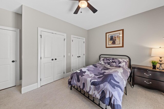 241 Clubside Dr, Lexington, SC 29072 - bedroom featuring light carpet, two closets, a ceiling fan, and baseboards