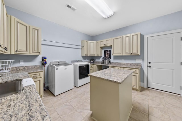 241 Clubside Dr, Lexington, SC 29072 - kitchen featuring cream cabinets, independent washer and dryer, light marble finish floors, a kitchen island, and light stone counters