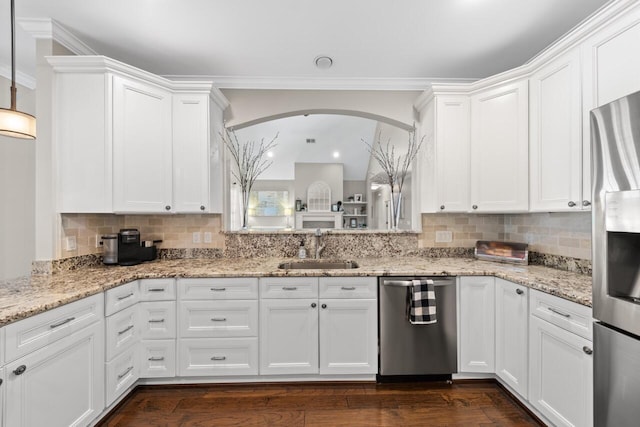 241 Clubside Dr, Lexington, SC 29072 - kitchen featuring stainless steel appliances, a sink, arched walkways, white cabinetry, and ornamental molding