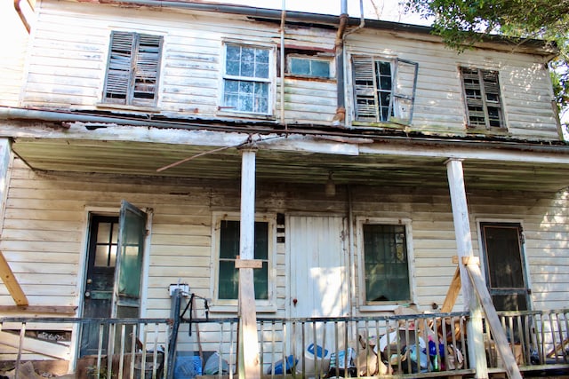 back of property featuring a porch