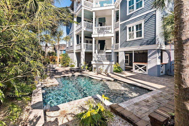 view of swimming pool featuring ceiling fan and a patio area