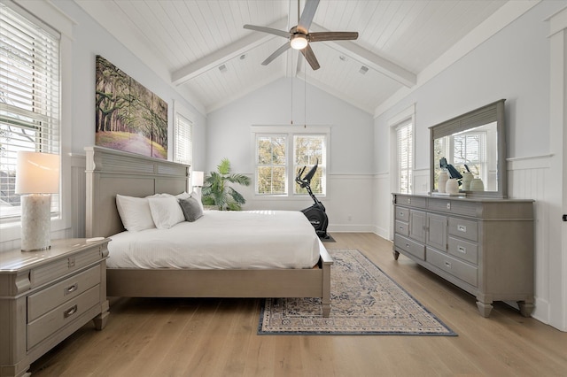 bedroom featuring ceiling fan, lofted ceiling with beams, and light hardwood / wood-style flooring