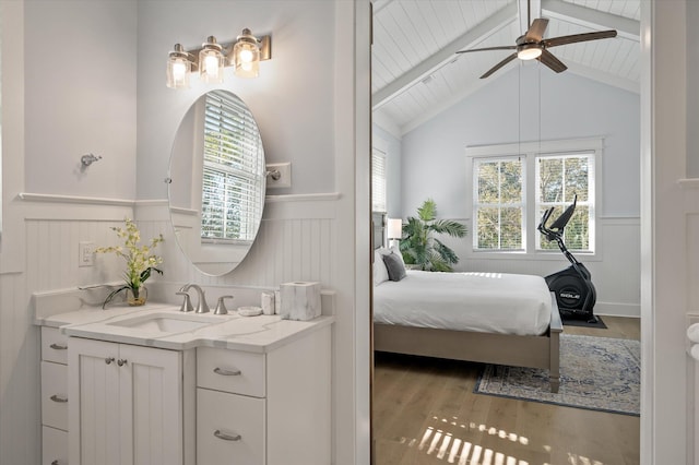 bathroom with vanity, hardwood / wood-style floors, lofted ceiling with beams, and ceiling fan