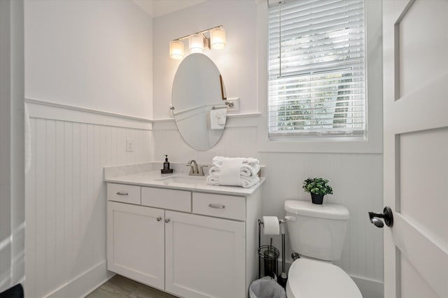 bathroom featuring tile patterned floors, vanity, and toilet