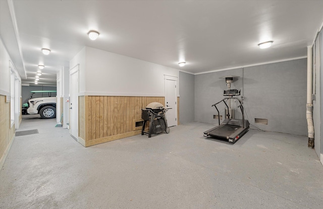 workout room featuring wood walls