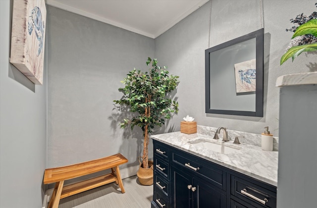 bathroom featuring vanity and ornamental molding