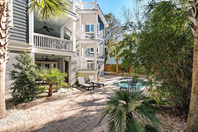 view of patio with a balcony and ceiling fan