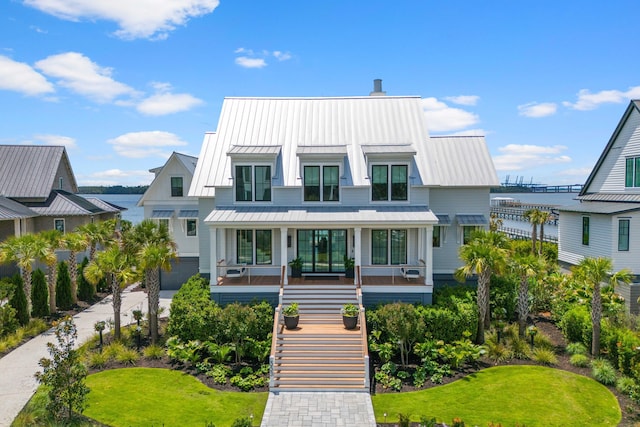 553 Old Compass Rd, Daniel Island, SC 29492 - view of front of home with a standing seam roof, covered porch, stairway, metal roof, and a front lawn
