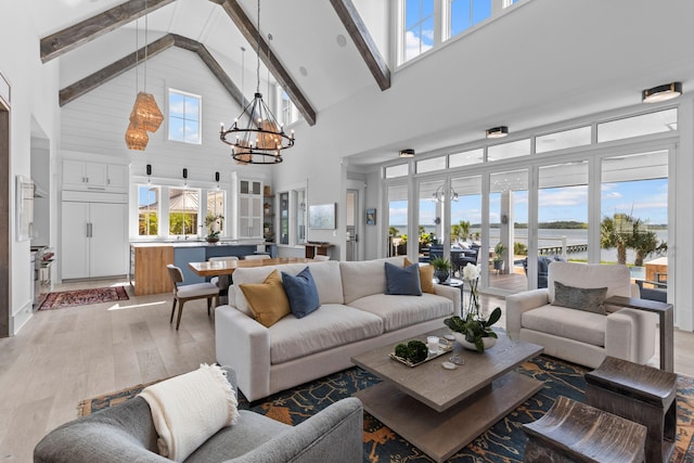 553 Old Compass Rd, Daniel Island, SC 29492 - living area with high vaulted ceiling, a chandelier, light wood-type flooring, and beam ceiling