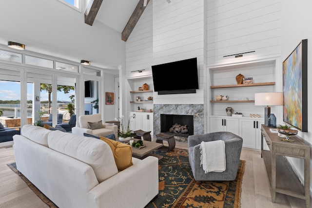 553 Old Compass Rd, Daniel Island, SC 29492 - living area with a high end fireplace, light wood finished floors, beamed ceiling, high vaulted ceiling, and built in shelves