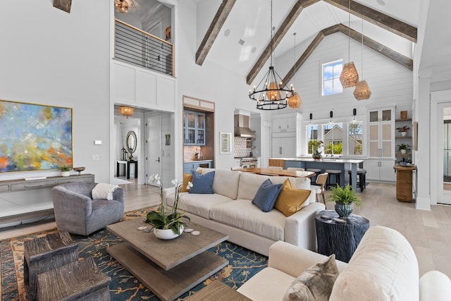 553 Old Compass Rd, Daniel Island, SC 29492 - living area with high vaulted ceiling, light wood finished floors, a chandelier, and beam ceiling
