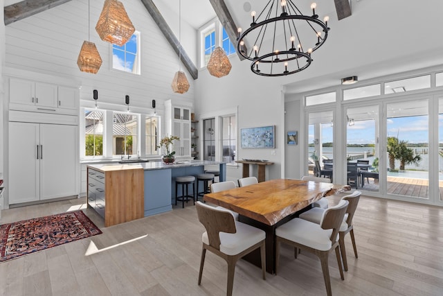 553 Old Compass Rd, Daniel Island, SC 29492 - dining area with a chandelier, high vaulted ceiling, beam ceiling, light wood finished floors, and a water view
