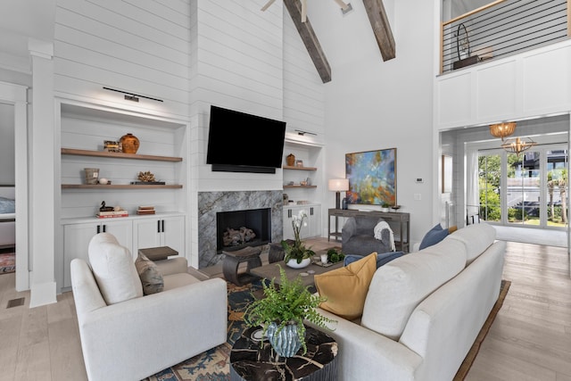 553 Old Compass Rd, Daniel Island, SC 29492 - living room with high vaulted ceiling, light wood-style floors, a premium fireplace, beamed ceiling, and a chandelier