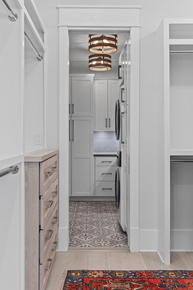 553 Old Compass Rd, Daniel Island, SC 29492 - walk in closet featuring light wood finished floors and a chandelier