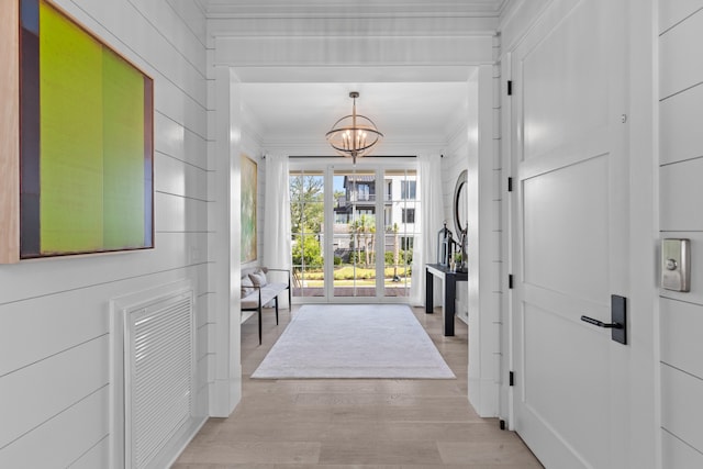 553 Old Compass Rd, Daniel Island, SC 29492 - foyer featuring ornamental molding, a chandelier, and light wood-style flooring