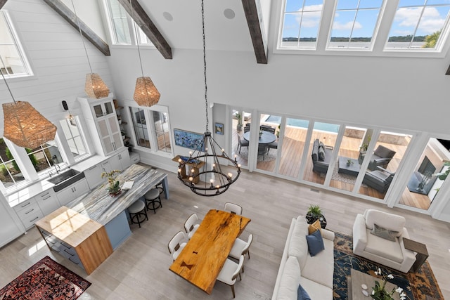 553 Old Compass Rd, Daniel Island, SC 29492 - living area with high vaulted ceiling, a chandelier, plenty of natural light, wood finished floors, and beamed ceiling