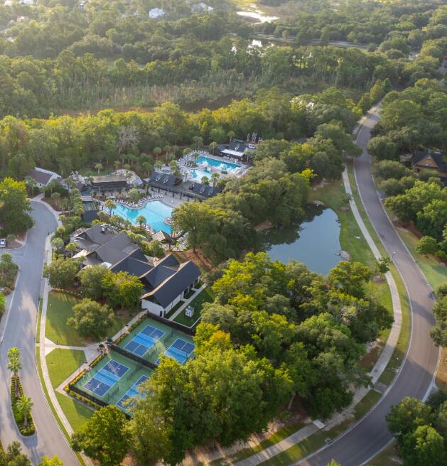 553 Old Compass Rd, Daniel Island, SC 29492 - drone / aerial view of a pool, a heavily wooded area, and a nearby body of water