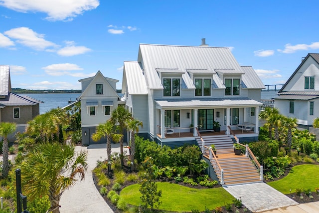 553 Old Compass Rd, Daniel Island, SC 29492 - view of front of property featuring covered porch, stairway, driveway, a water view, and a carport