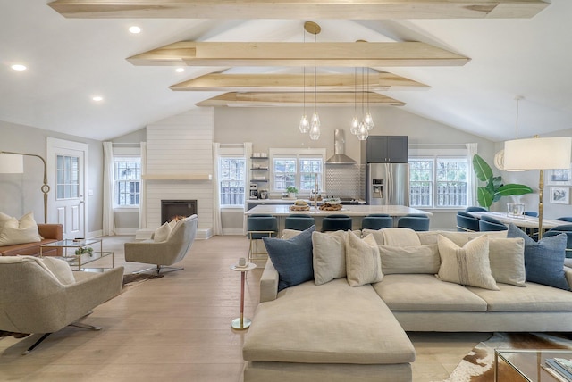 living room featuring a notable chandelier, a fireplace, high vaulted ceiling, beamed ceiling, and light hardwood / wood-style floors