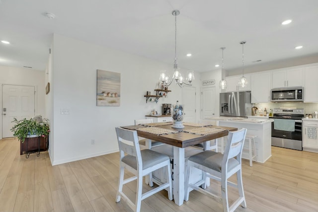 432 Eva St, Moncks Corner, SC 29461 - dining space with light hardwood / wood-style floors and an inviting chandelier
