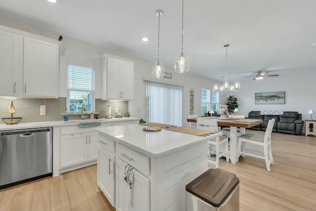 432 Eva St, Moncks Corner, SC 29461 - kitchen with light wood-type flooring, backsplash, pendant lighting, dishwasher, and white cabinetry