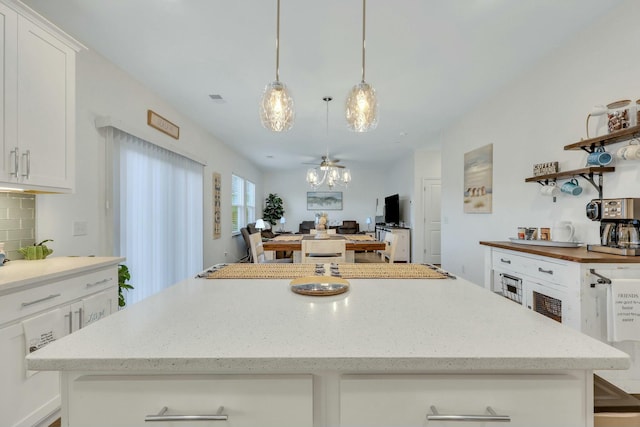 432 Eva St, Moncks Corner, SC 29461 - kitchen with white cabinets, decorative light fixtures, tasteful backsplash, and a notable chandelier