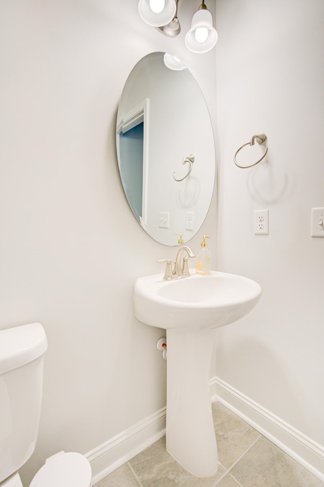 bathroom with sink, tile patterned flooring, and toilet