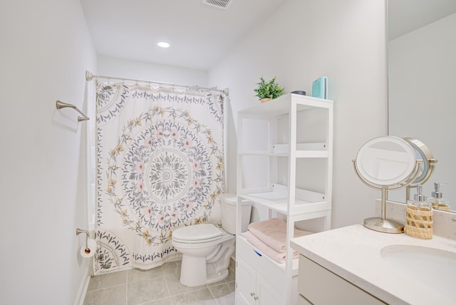 bathroom featuring tile patterned floors, vanity, toilet, and curtained shower