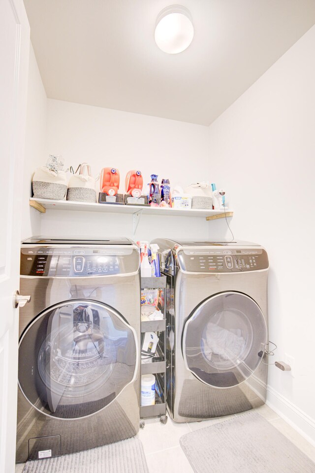 laundry room featuring independent washer and dryer and light tile patterned floors