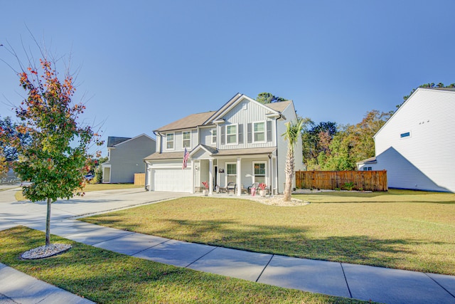 view of front of property with a porch, a garage, and a front lawn