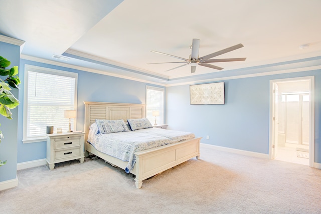 bedroom featuring multiple windows, ensuite bathroom, ceiling fan, and light colored carpet