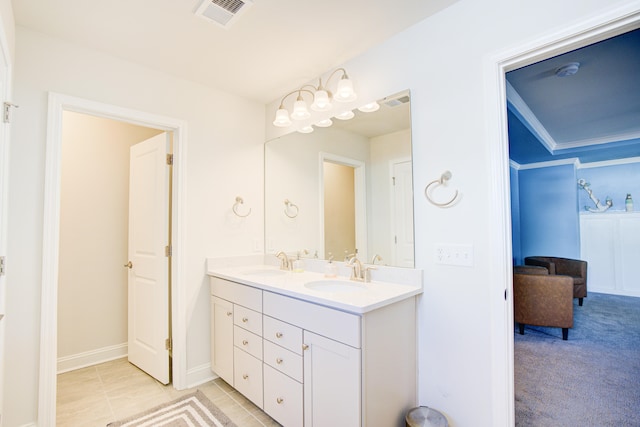 bathroom with tile patterned flooring, vanity, and crown molding