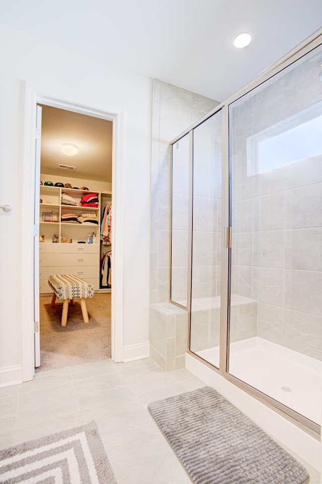 bathroom with tile patterned flooring and an enclosed shower