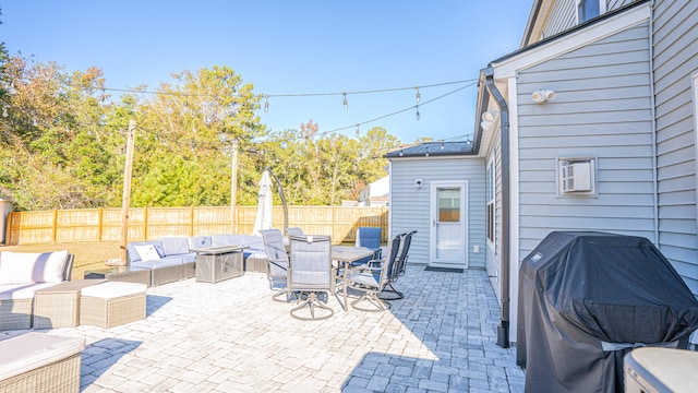 view of patio with outdoor lounge area and a grill