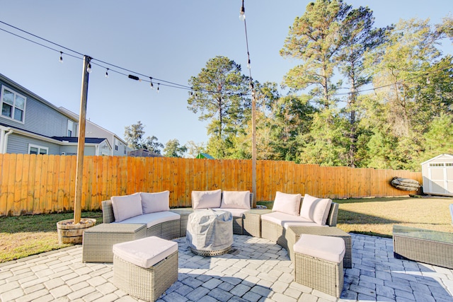 view of patio / terrace with outdoor lounge area and a storage unit