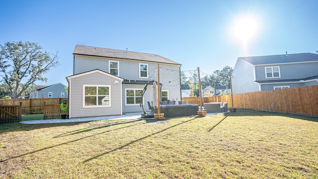 back of property featuring outdoor lounge area and a yard