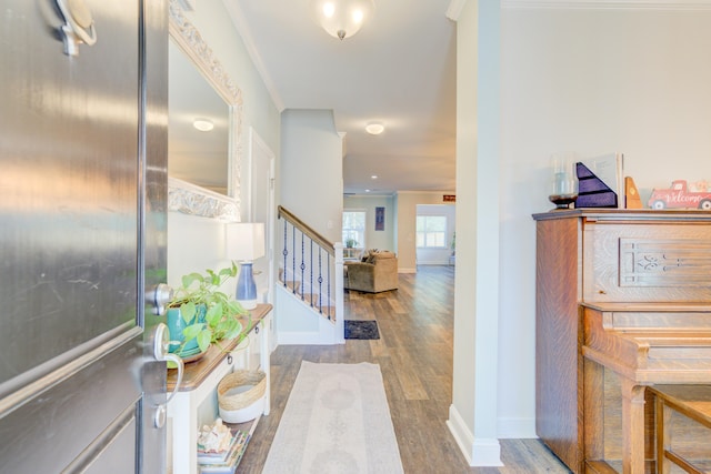 entrance foyer with hardwood / wood-style floors and ornamental molding