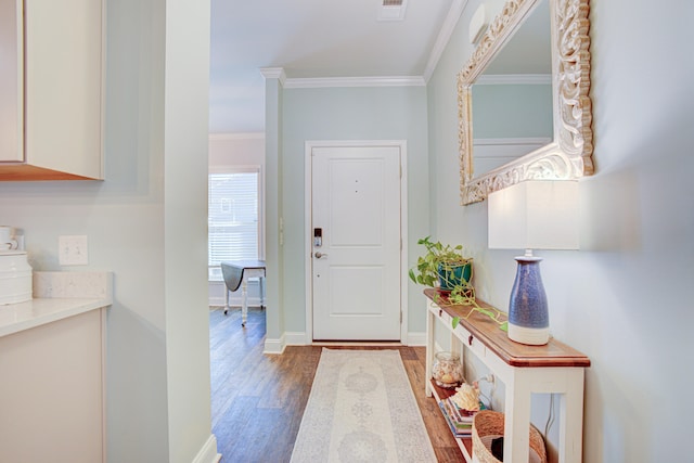 foyer entrance with dark hardwood / wood-style flooring and crown molding