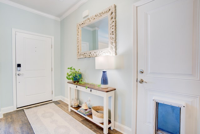 foyer with dark hardwood / wood-style floors and crown molding